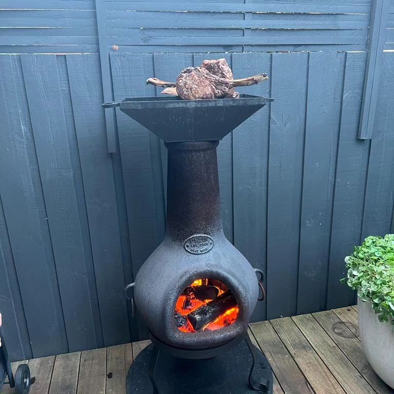 Cooking a steak on a chiminea