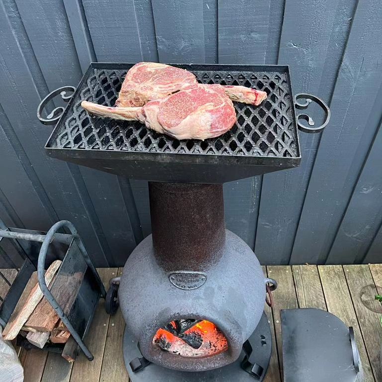 Cooking a steak on a chiminea