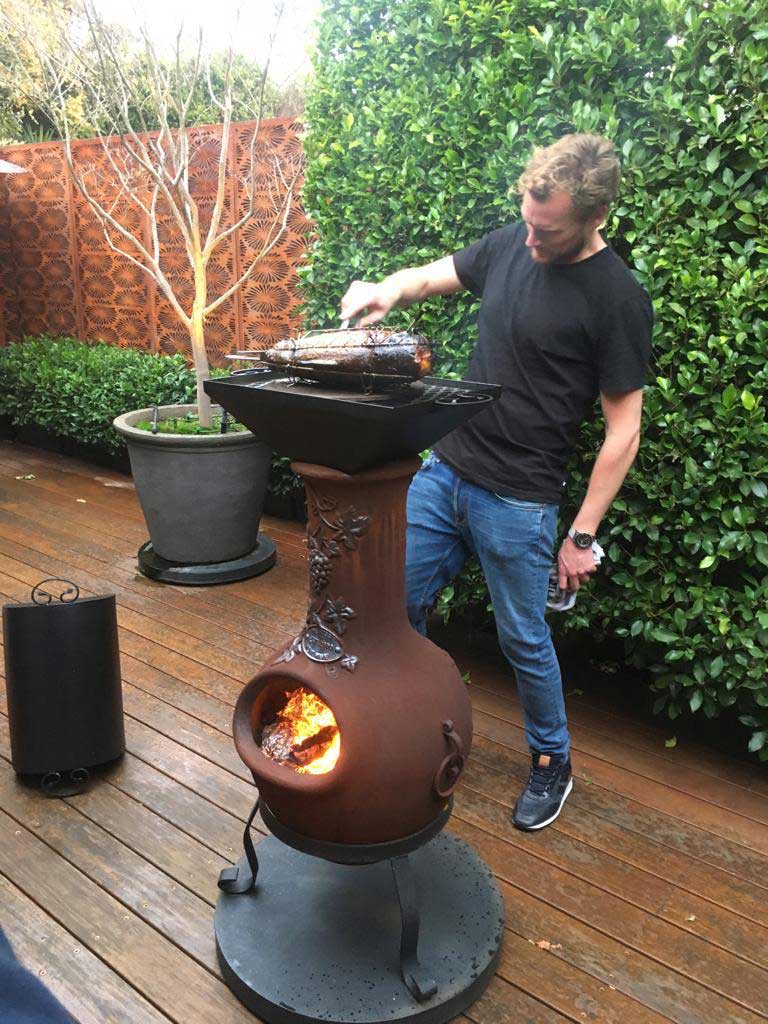 Cooking a fish on a chiminea