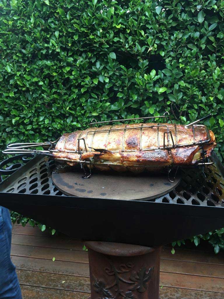 Cooking a fish on a chiminea