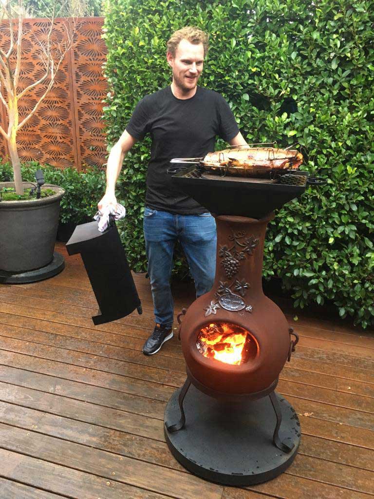 Cooking a fish on a chiminea